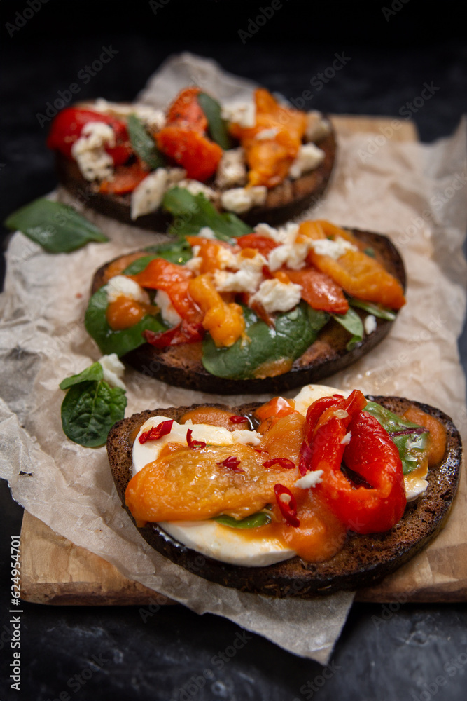 bruschetta set with herbs, cheese, and roasted peppers. bruschetta set with herbs, cheese, and roasted peppers.