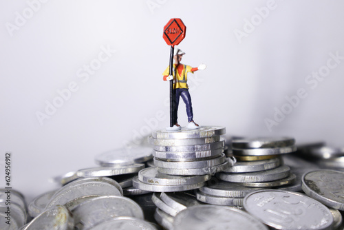 miniature people on the peak of groups coins