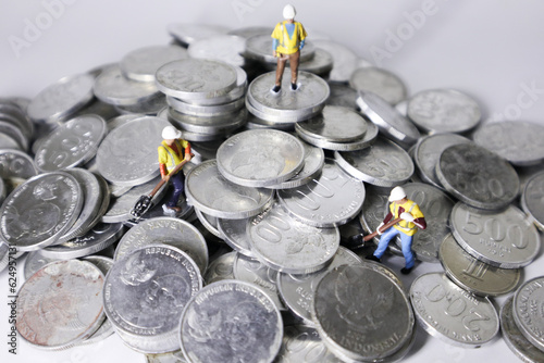 miniature people on the group of coins