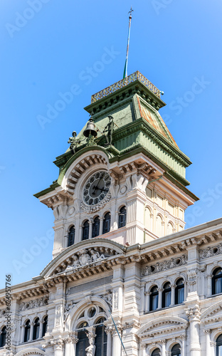 The clock tower of Trieste City Hall, built in 19th century in eclectic style, in piazza Unità d'Italia (Unity of Italy Square), Trieste city center, Italy