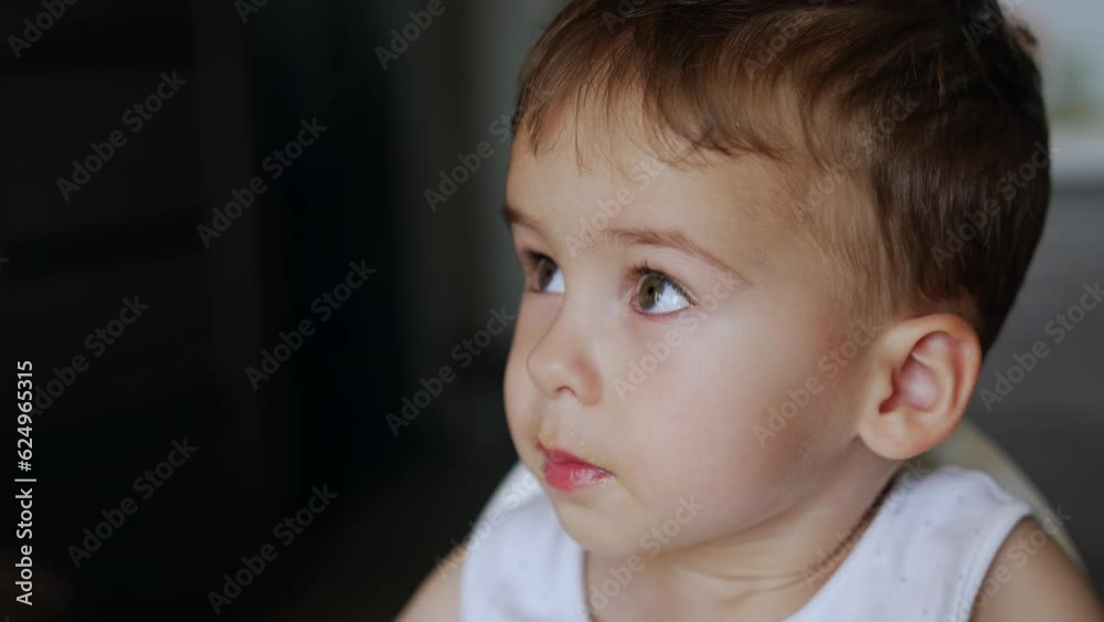 Little Caucasian boy refusing to eat. Child turns away but finally takes the food. Close up portrait. Little Caucasian boy refusing to eat. Child turns away but finally takes the food. Close up portrait.