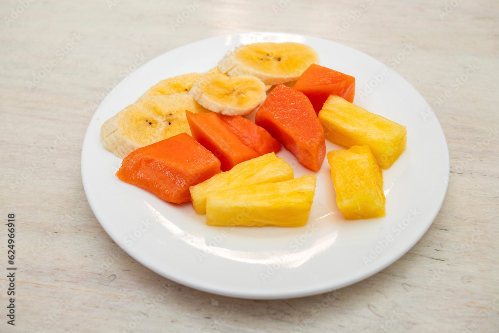 Chopped fruit for breakfast - Pineapple, banana and papaya. Chopped fruit for breakfast - Pineapple, banana and papaya.