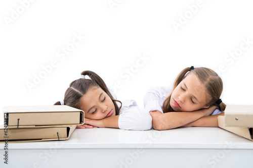 tired and sleepy. two girls in school class. education and knowledge. children girls holding folder. high school education. school education for girls. children girls on desk. ready for school lesson photo