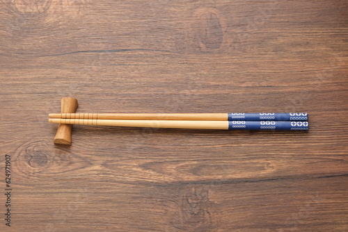 Wooden chopsticks on wooden table, copy space
 photo