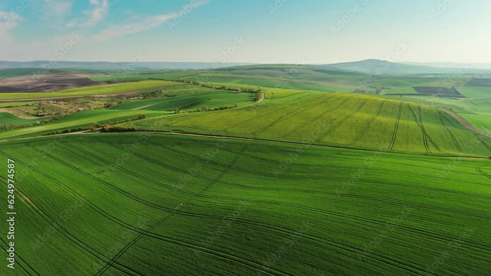 Aerial view of amazing green wavy hills with agricultural fields in spring. South Moravia region, Czech Republic, Europe, 4k Aerial view of amazing green wavy hills with agricultural fields in spring. South Moravia region, Czech Republic, Europe, 4k