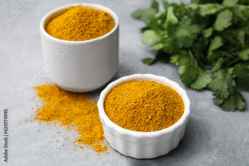 Aromatic curry powder on light grey table  closeup