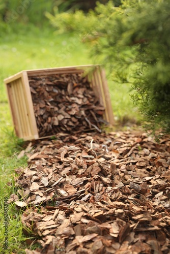 Wooden box with bark chips in garden