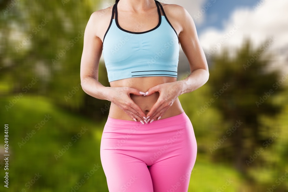 Fototapeta premium Woman hold her hands on stomach in heart sign