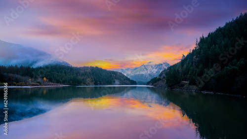 sunrise reflection on lake with winter mountain,
