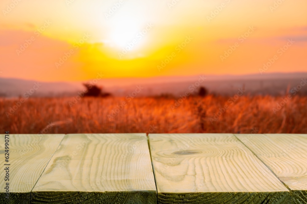 Wooden table on blur field background