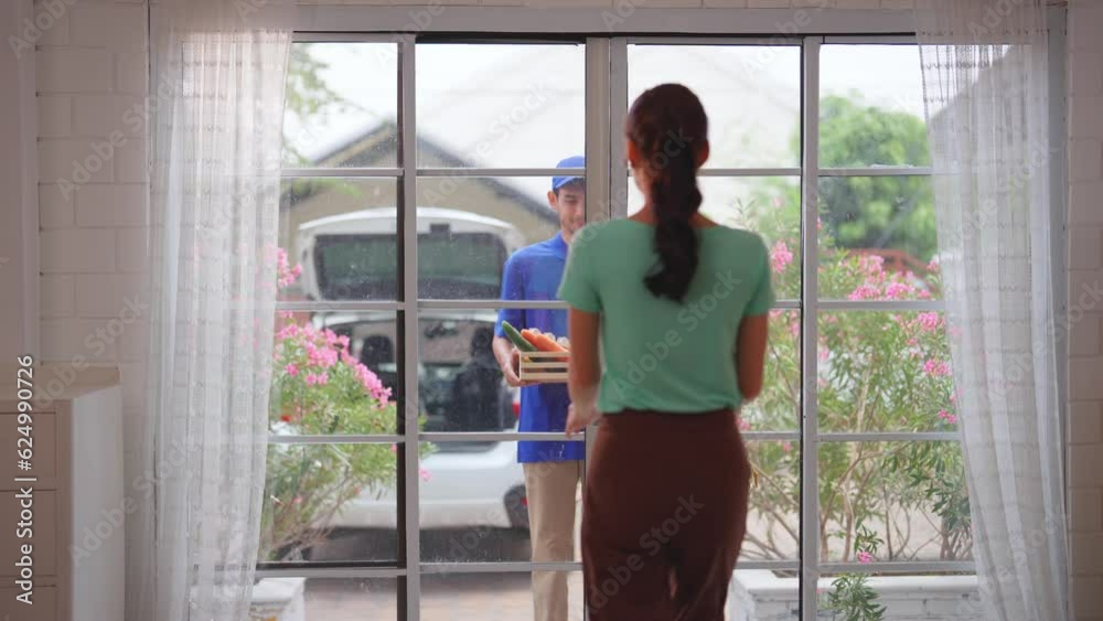 Asian young delivery man delivering package to female customer at home. Asian young delivery man delivering package to female customer at home.