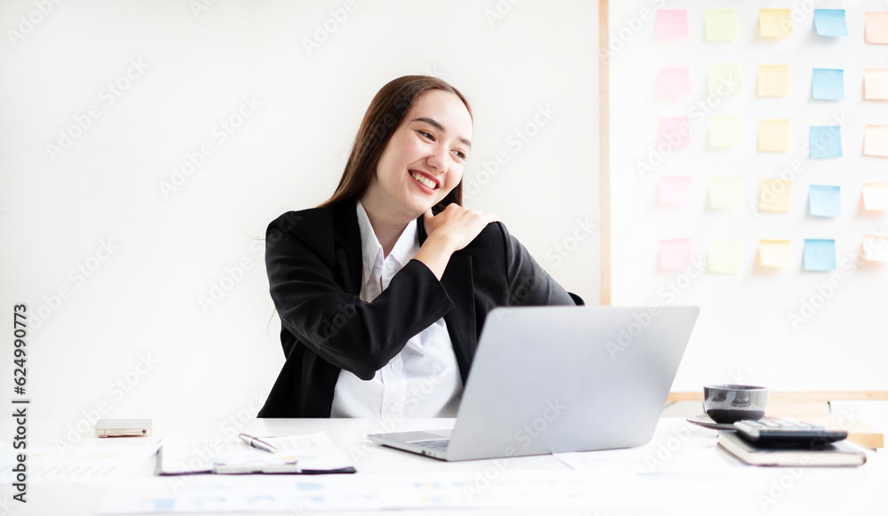 Asian female accountant is tired from working in a chair, stretching to relax and relax while working hard at the office Asian female accountant is tired from working in a chair, stretching to relax and relax while working hard at the office