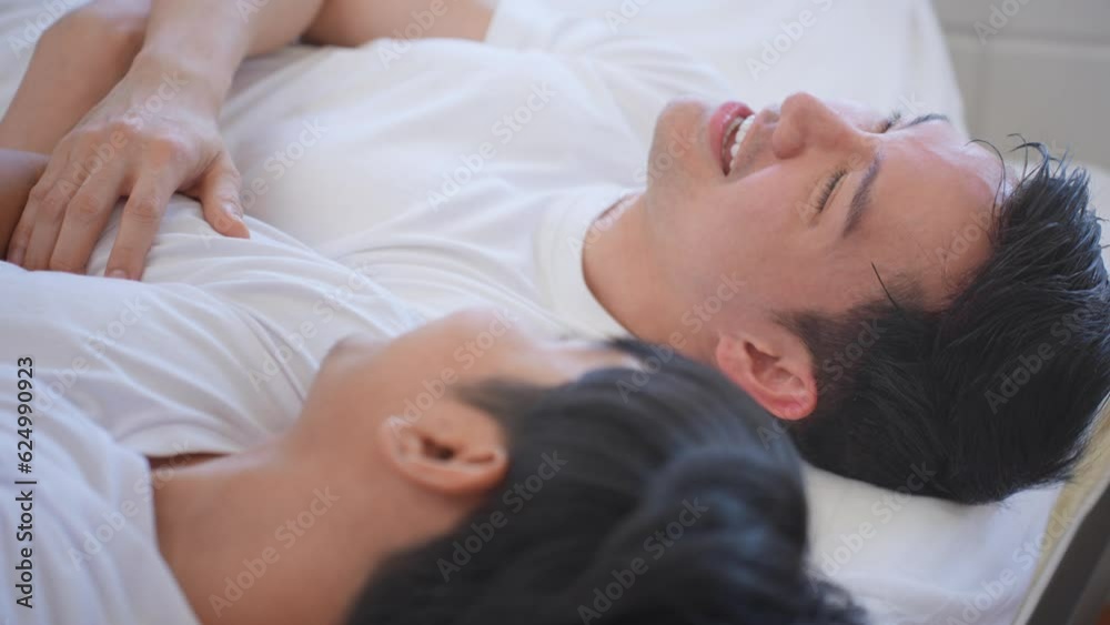 Asian young male gay family lying down on bed and look at each other. Asian young male gay family lying down on bed and look at each other.