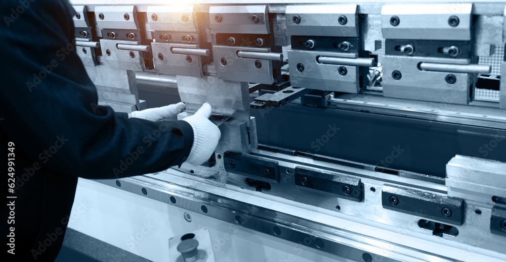 The technician operator use metal cutting and bending machine The technician operator use metal cutting and bending machine
