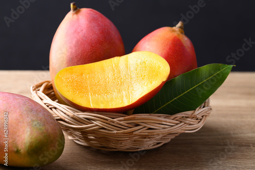 Mango fruit (Palmer mango) in basket on wooden background, Tropical fruit