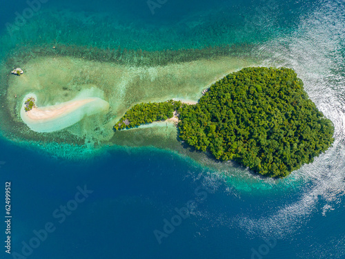Aerial view of tropical island with sandbar beach with waves and turquoise water atoll. Millari Island. Mindanao, Philippines. Summer and travel concept.