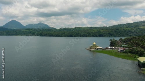 Aerial view of Linuk Mosque and Lake Lanao in Lanao del Sur. Blue sky and clouds. Mindanao, Philippines. photo