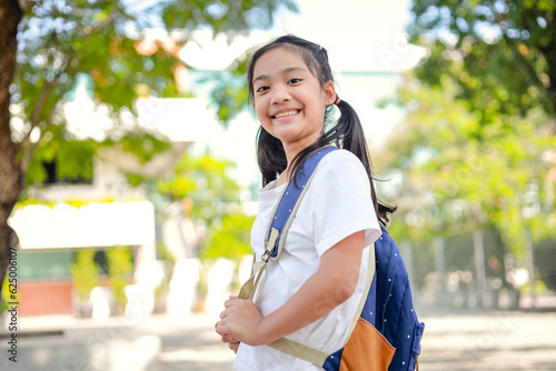 Little kid girl asian with a backpack going to school with fun. which increases the development and enhances the learning skills. Concept Back to school.