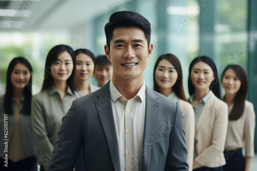 Asian business team standing and smile in the office