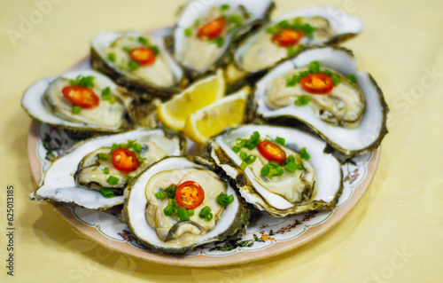 Raw oyster served with lemon and pepper