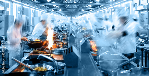 Motion chefs working in Chinese restaurant kitchen
