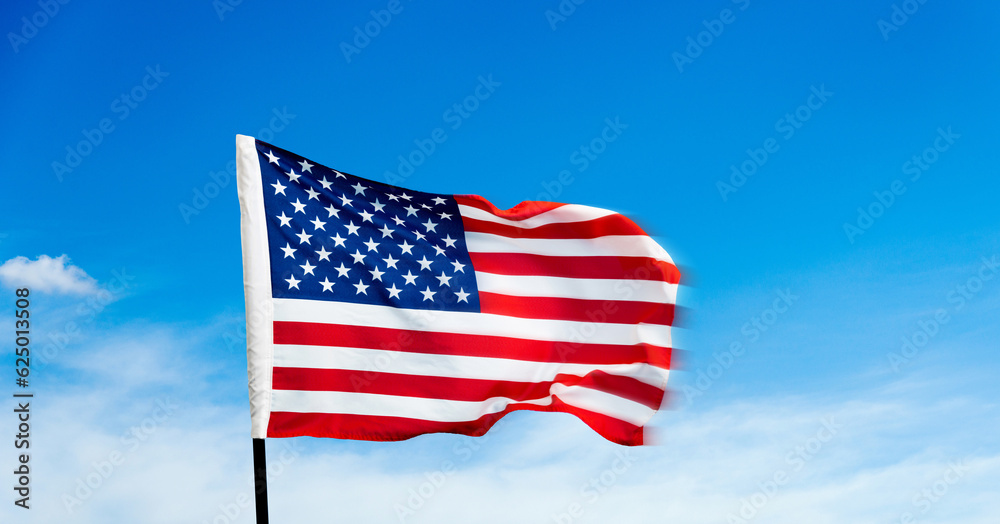 Obraz premium American flag waving on blue sky background