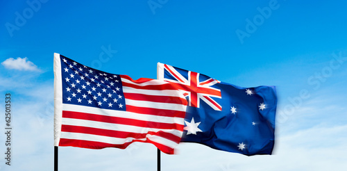 USA and Australia flags against blue sky background photo