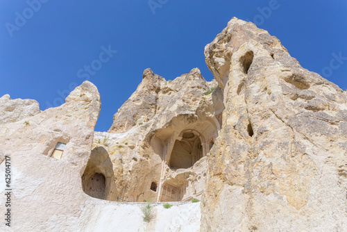 Entrance to the Dark church in volcanic landscape at Goreme Open air museum. Mediaeval monastery on cliffs, so-called 'Turkish Petra', famouse tourist attraction. Cappadocia, Turkey