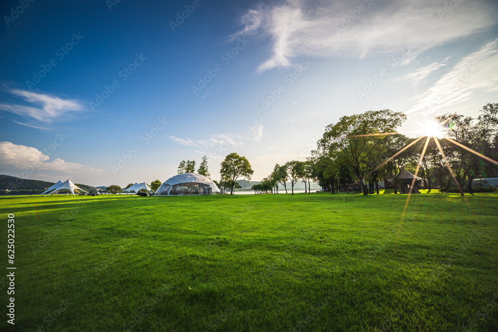 Camping tent on the grass in a sunny day - obrazy, fototapety, plakaty 