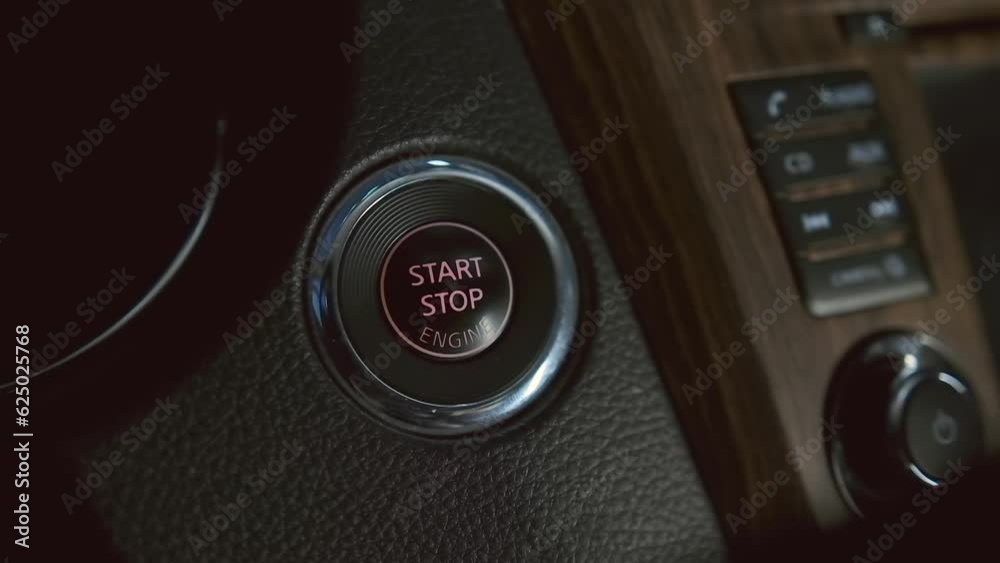 Man hand pushing start stop button in car. Close up male hand starting