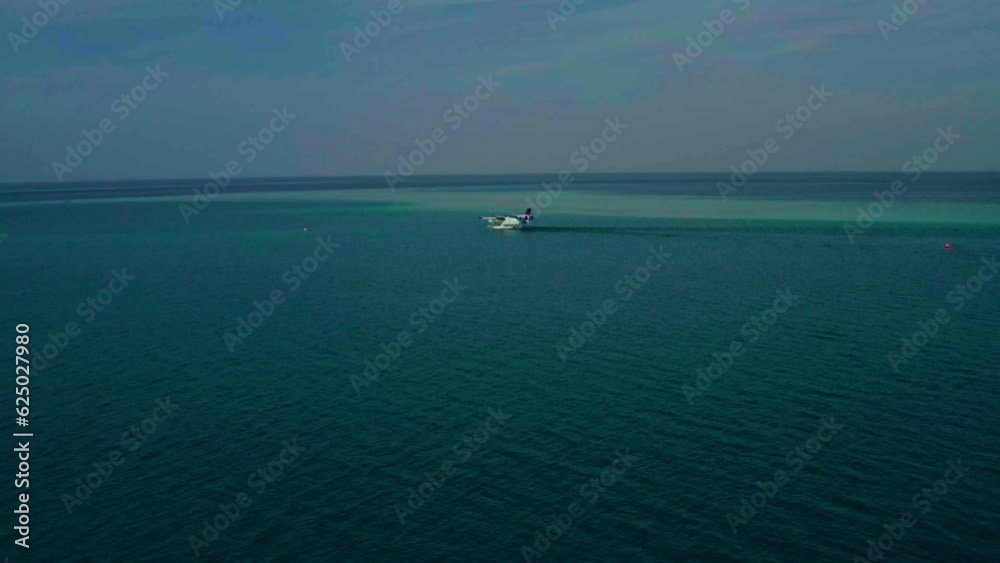 Seaplane stands on the water. Transportation of Maldivian tourists by air on a seaplane. Seaplane stands on the water. Transportation of Maldivian tourists by air on a seaplane.