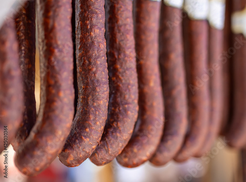 Spicy sausages hanging in market
