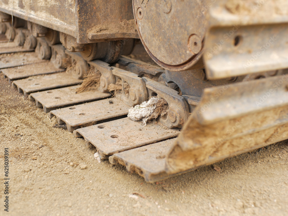 Metal excavator track background. Construction site sandy ground. House building background. Heavy machinery equipment