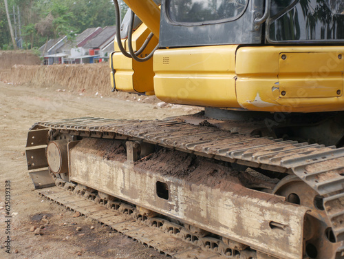 Metal excavator track background. Construction site sandy ground. House building background. Heavy machinery equipment