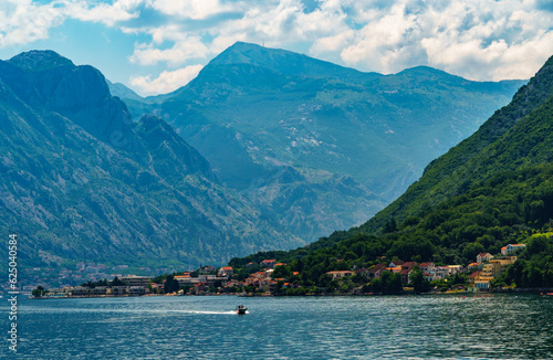 seascapes, a view of the Bay of Kotor during a cruise on a ship in Montenegro, a bright sunny day, mountains and small towns on the coast, the concept of a summer trip