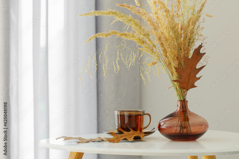 cup of tea and autumn decor in modern interior