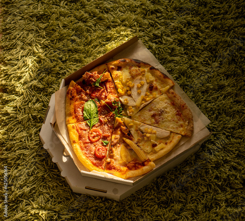 Pizza a green carpet on a sunny day.