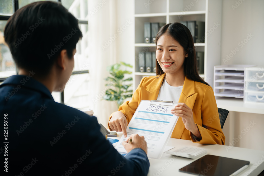 Signing a contract. Client and broker agent, lease agreement, successful deal and Young business sitting at the desk in office . Signing a contract. Client and broker agent, lease agreement, successful deal and Young business sitting at the desk in office .
