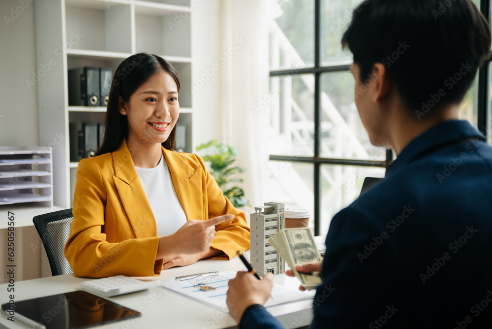 Signing a contract. Client and broker agent, lease agreement, successful deal and Young business sitting at the desk in office . Signing a contract. Client and broker agent, lease agreement, successful deal and Young business sitting at the desk in office .