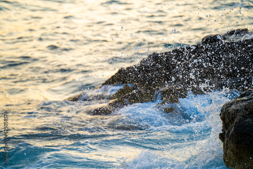 Waves and foam hitting the rock on the seashore. © Erman Gunes
