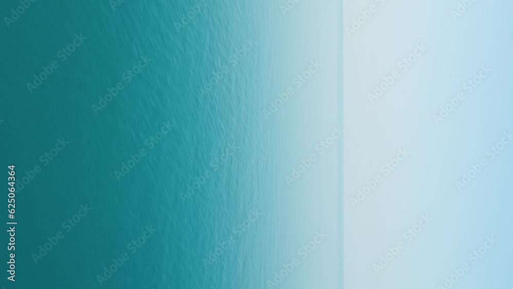 Abstract aerial sea summer ocean sunset nature background. Small waves on water surface in motion blur with golden bokeh lights from sun. Holiday, vacation and recreational concept. Vertical video Abstract aerial sea summer ocean sunset nature background. Small waves on water surface in motion blur with golden bokeh lights from sun. Holiday, vacation and recreational concept. Vertical video