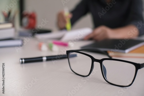 Student writes information from portable tablet while prepare for lectures in University campus