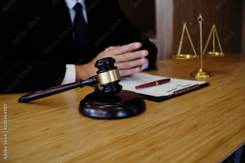 Legal counsel presents to the client a signed contract with gavel and legal law. justice and lawyer concept. Legal counsel presents to the client a signed contract with gavel and legal law. justice and lawyer concept.