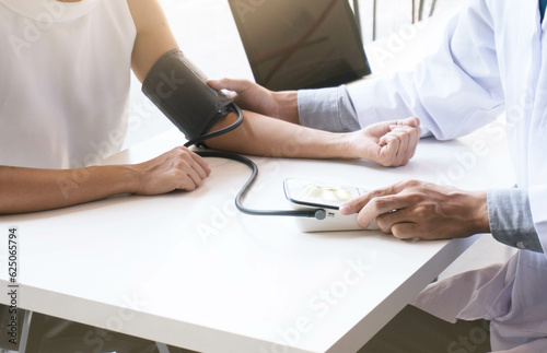 Doctor checking old woman patient arterial blood pressure. Health care.