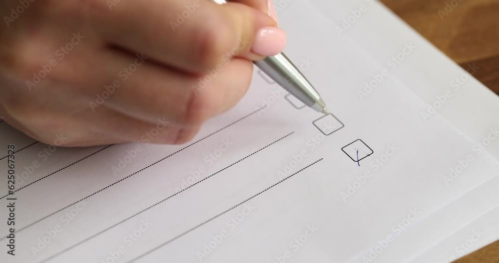 Woman ticks empty boxes filling out application form questionnaire in office. Client sits at wooden table filling points with pen on paper slow motion
