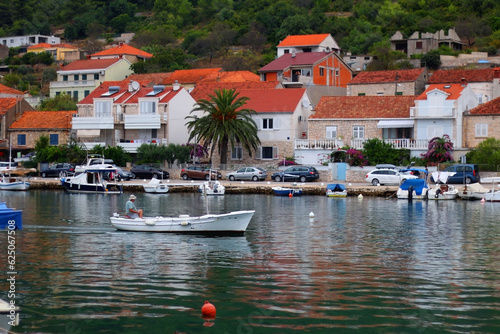 Small fishing boat and picturesque skyline in Vela Luka, island Korcula, Croatia.