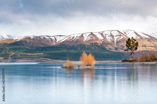 Scenic sunrise view of Lake Pukaki east bank, with their mesmerizing turquoise hue and reflect the majestic snow-capped Southern Alps. Perfect for travel brochures, and nature magazines. photo