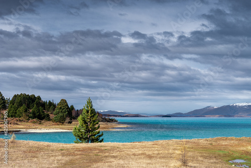 Fototapeta Naklejka Na Ścianę i Meble -  Scenic sunrise view of Lake Pukaki east bank, with their mesmerizing turquoise hue and reflect the majestic snow-capped Southern Alps. Perfect for travel brochures, and nature magazines.