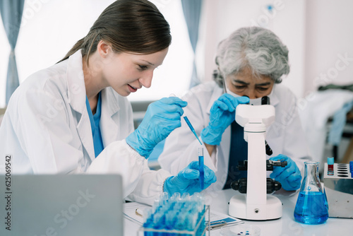 Scientist works with a pipette and a test tube. Scientific laboratory of biotechnology, development of medicine and research in chemistry, biochemistry and experiments.