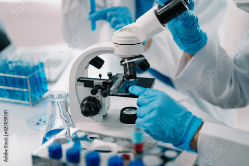 Scientist works with a pipette and a test tube. Scientific laboratory of biotechnology, development of medicine and research in chemistry, biochemistry and experiments.